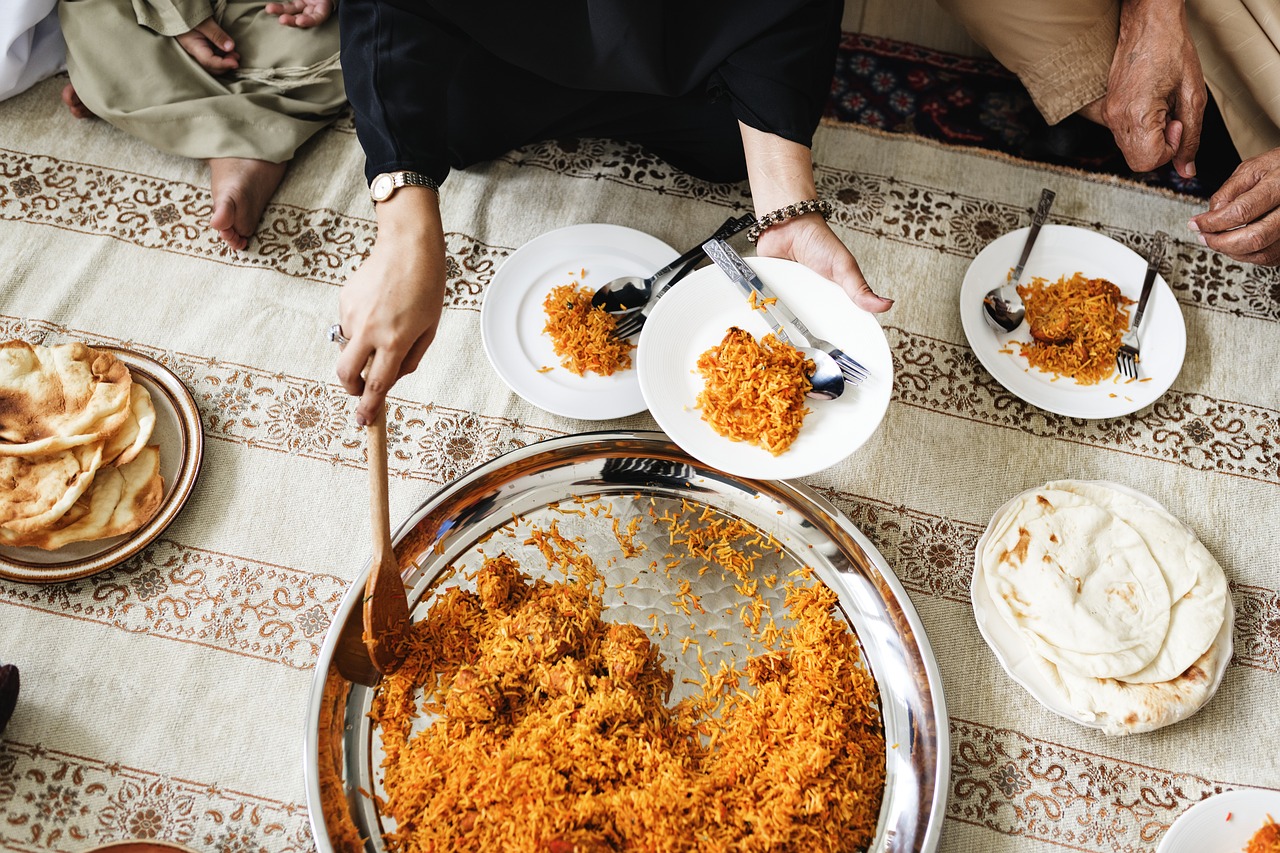lady serving biriyani to a plate