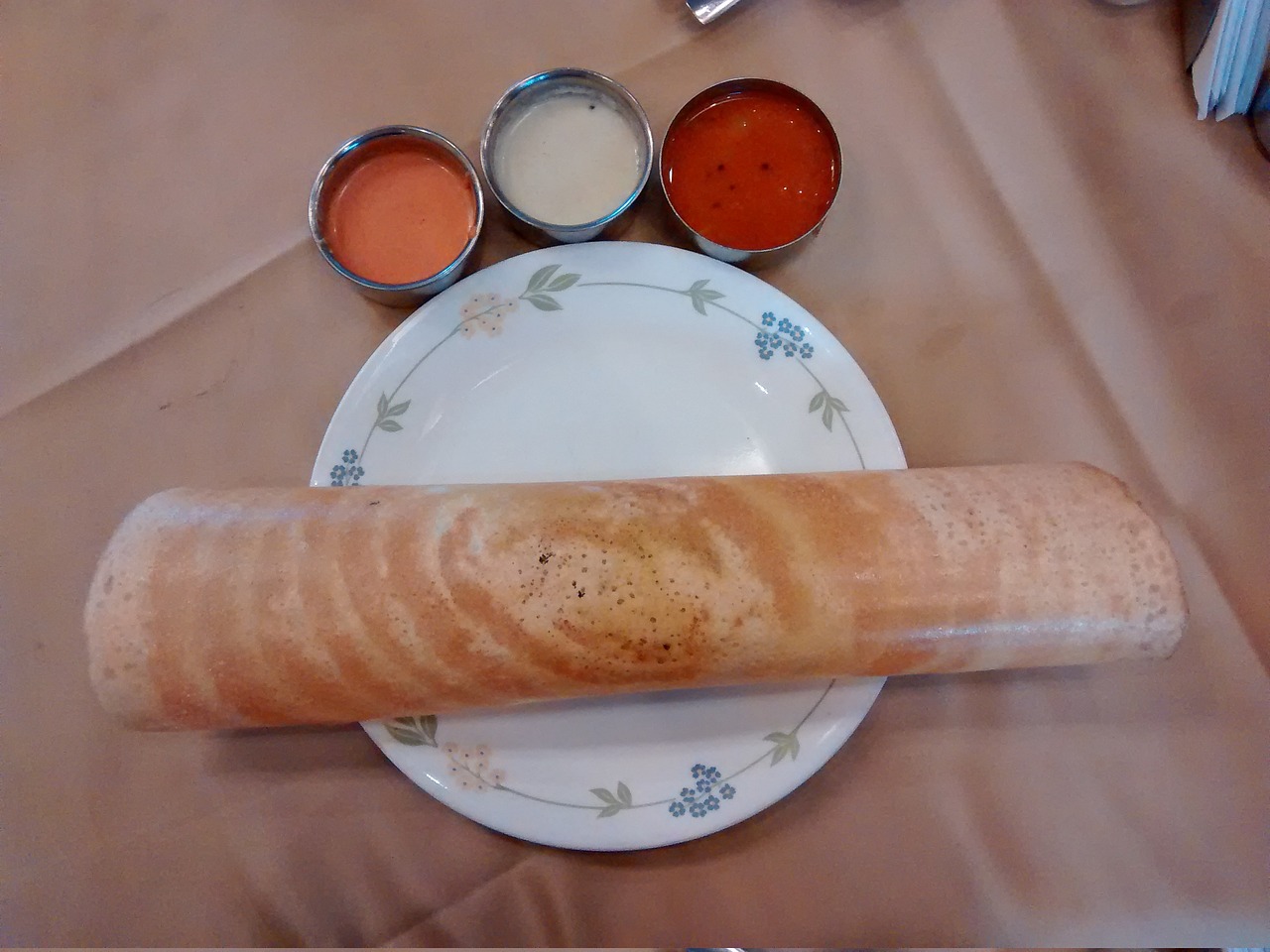 a plate with masala dosa chutney and sambar