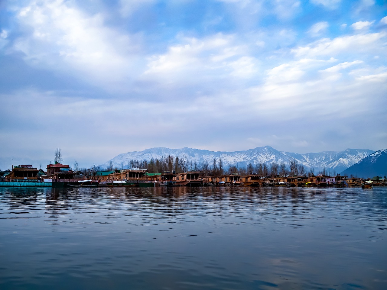 a lake and behind a white snowy landscape in Srinagar