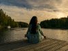 Women doing yoga on lakeside